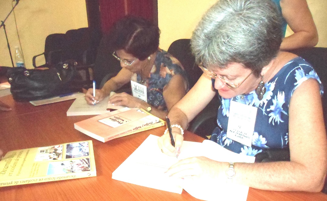 Celia and Nancy autographing their books